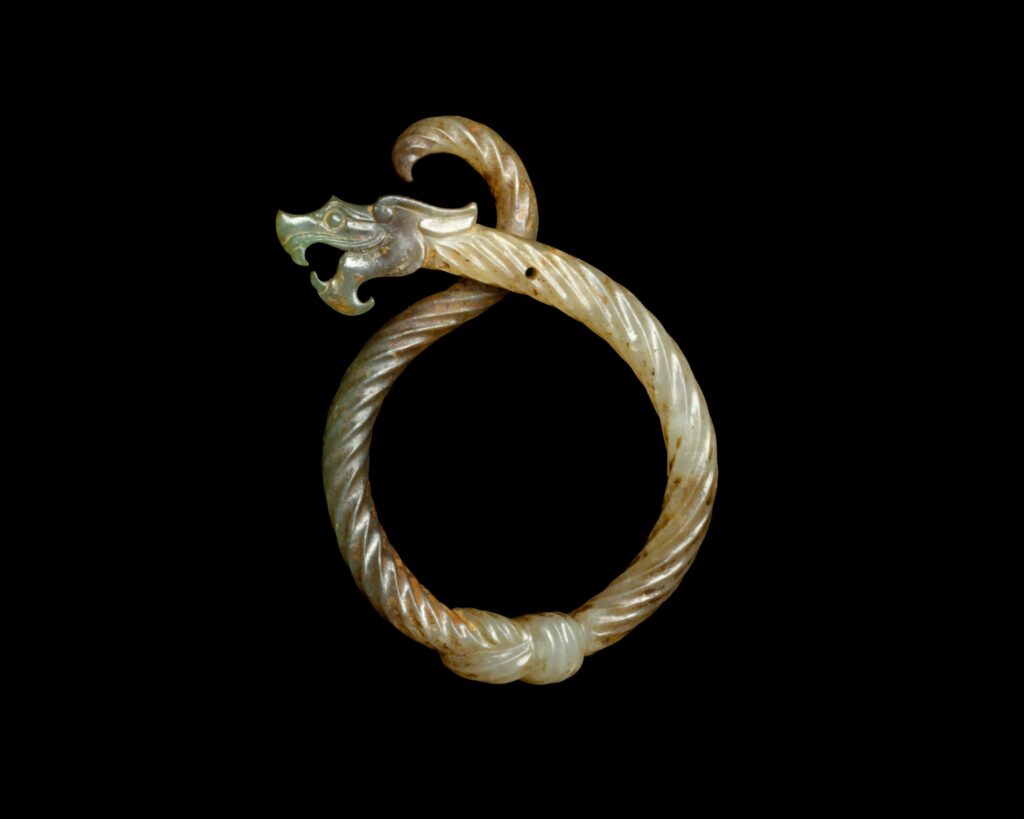 Nephrite jade ring carved in the form of a knotted dragon, China, 3rd century BCE